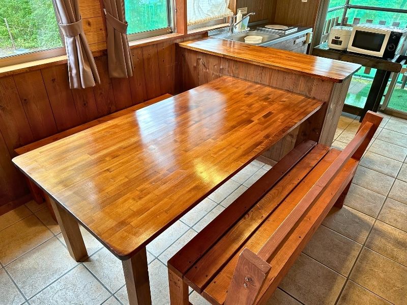 Wooden dining table and bench in the family lodge kitchen area