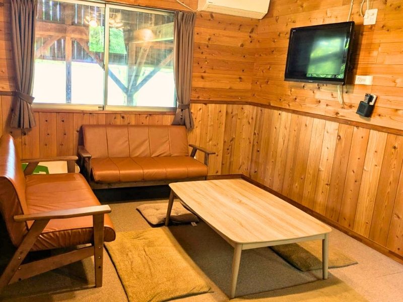 Cozy wood-paneled living area with a sofa and low table