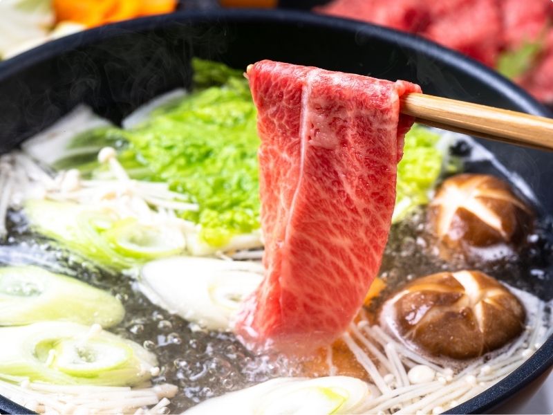 Wagyu beef being cooked shabu-shabu style in a hot pot