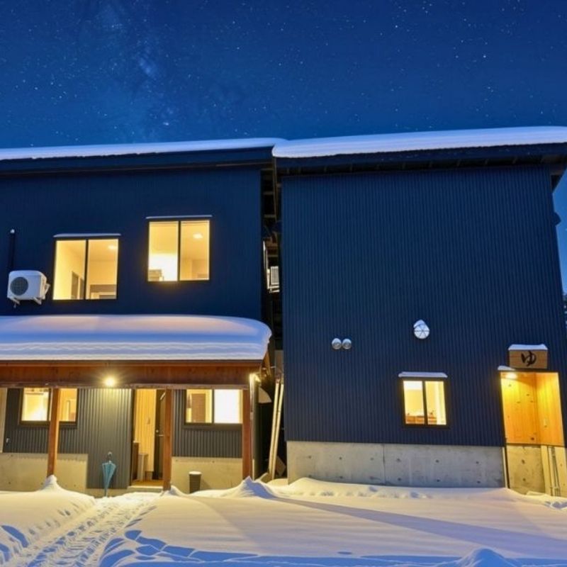 Private bath building at Donguri Mura, lit up at night